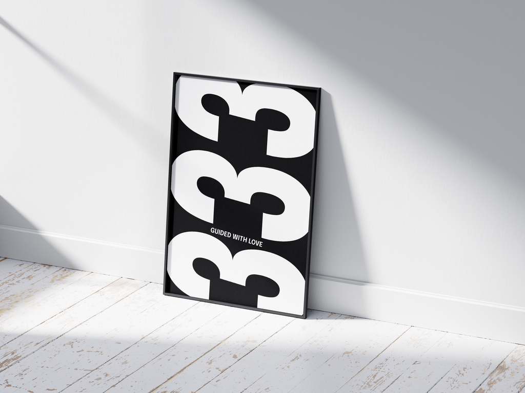 Minimalist black and white abstract poster featuring the repeated number 333 design and the quote "Guided with love," framed and leaning against a white wall. Inspiring modern wall art for a creative, contemporary home or office interior.