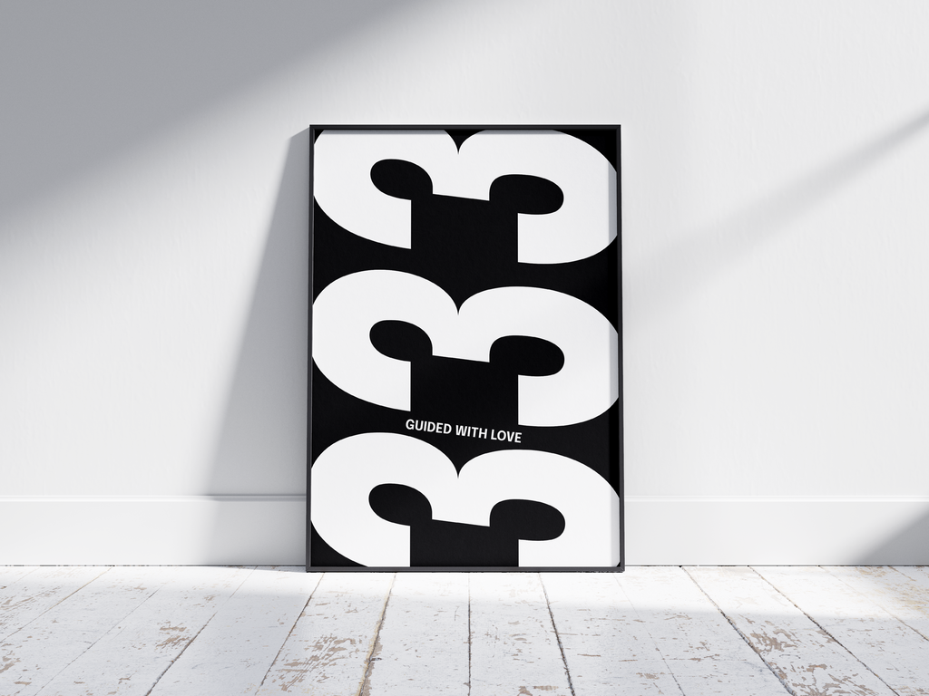 Minimalist black and white abstract poster featuring the repeated number 333 design and the quote "Guided with love," framed and leaning against a white wall. Inspiring modern wall art for a creative, contemporary home or office interior.