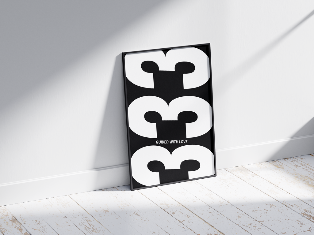 Minimalist black and white abstract poster featuring the repeated number 333 design and the quote "Guided with love," framed and leaning against a white wall. Inspiring modern wall art for a creative, contemporary home or office interior.