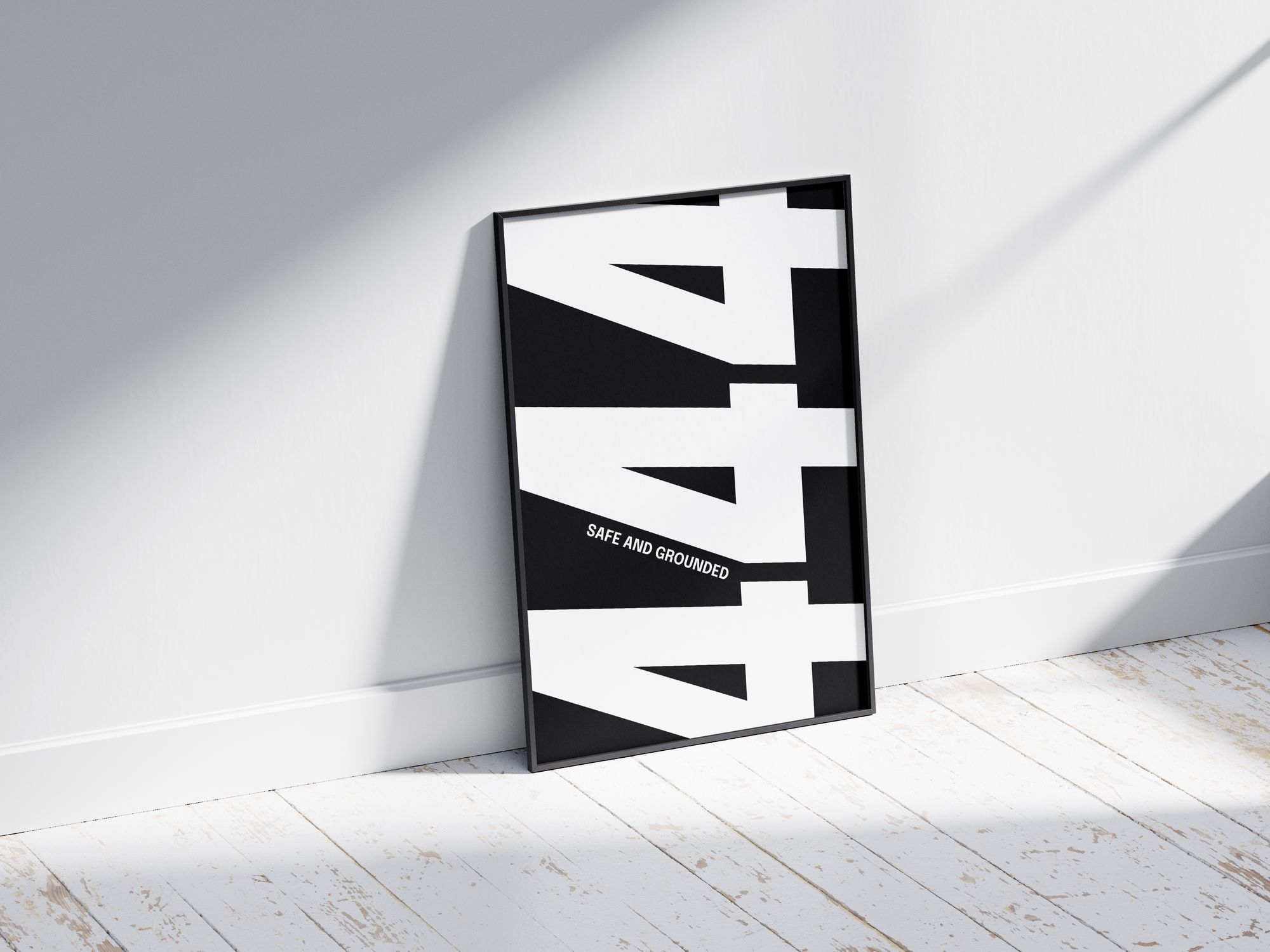 Minimalist black and white abstract poster featuring the repeated number 444 design and the quote "Safe and grounded," framed and leaning against a white wall. Inspiring modern wall art for a secure, contemporary home or office interior.