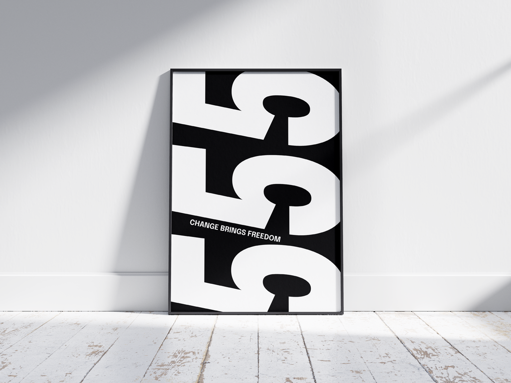 Minimalist black and white abstract poster featuring the repeated number 555 design and the quote "Change brings freedom," framed and leaning against a white wall. Inspiring modern wall art for a transitional, contemporary home or office interior.