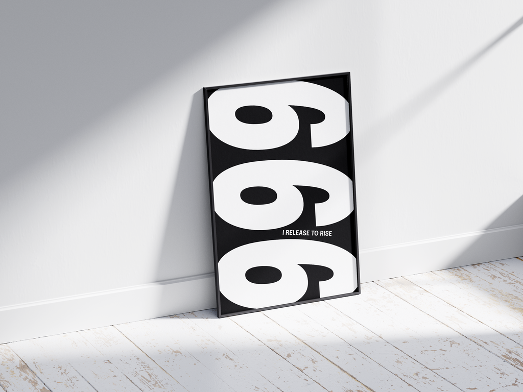 Minimalist black and white abstract poster featuring the repeated number 999 design and the quote "I release to rise," framed and leaning against a white wall. Inspiring modern wall art for a transformative, contemporary home or office interior.