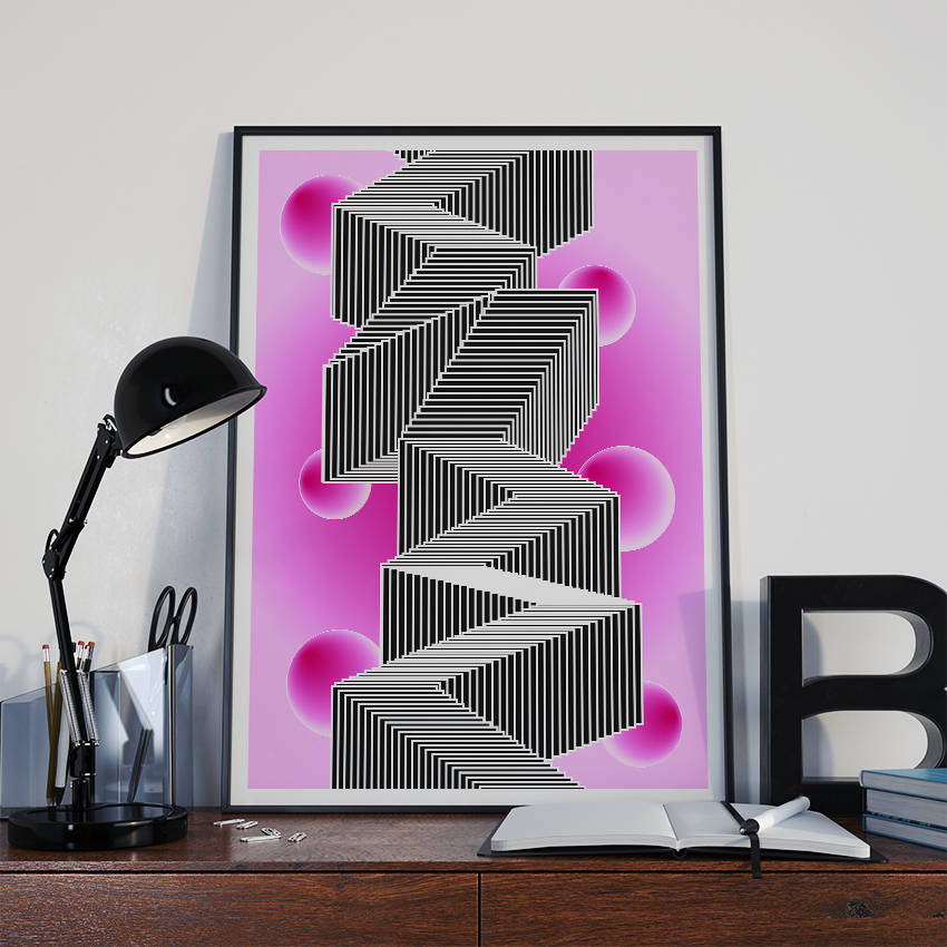 A striking, vertically oriented poster featuring a black and white optical illusion of stacked, zigzagging cubes stands on a dark wooden desk. The background of the poster is a vibrant pink and purple gradient with several glowing, magenta spheres floating around the central geometric shape. To the left, a black, adjustable desk lamp with a round head is positioned over a metal organizer holding pens and scissors.