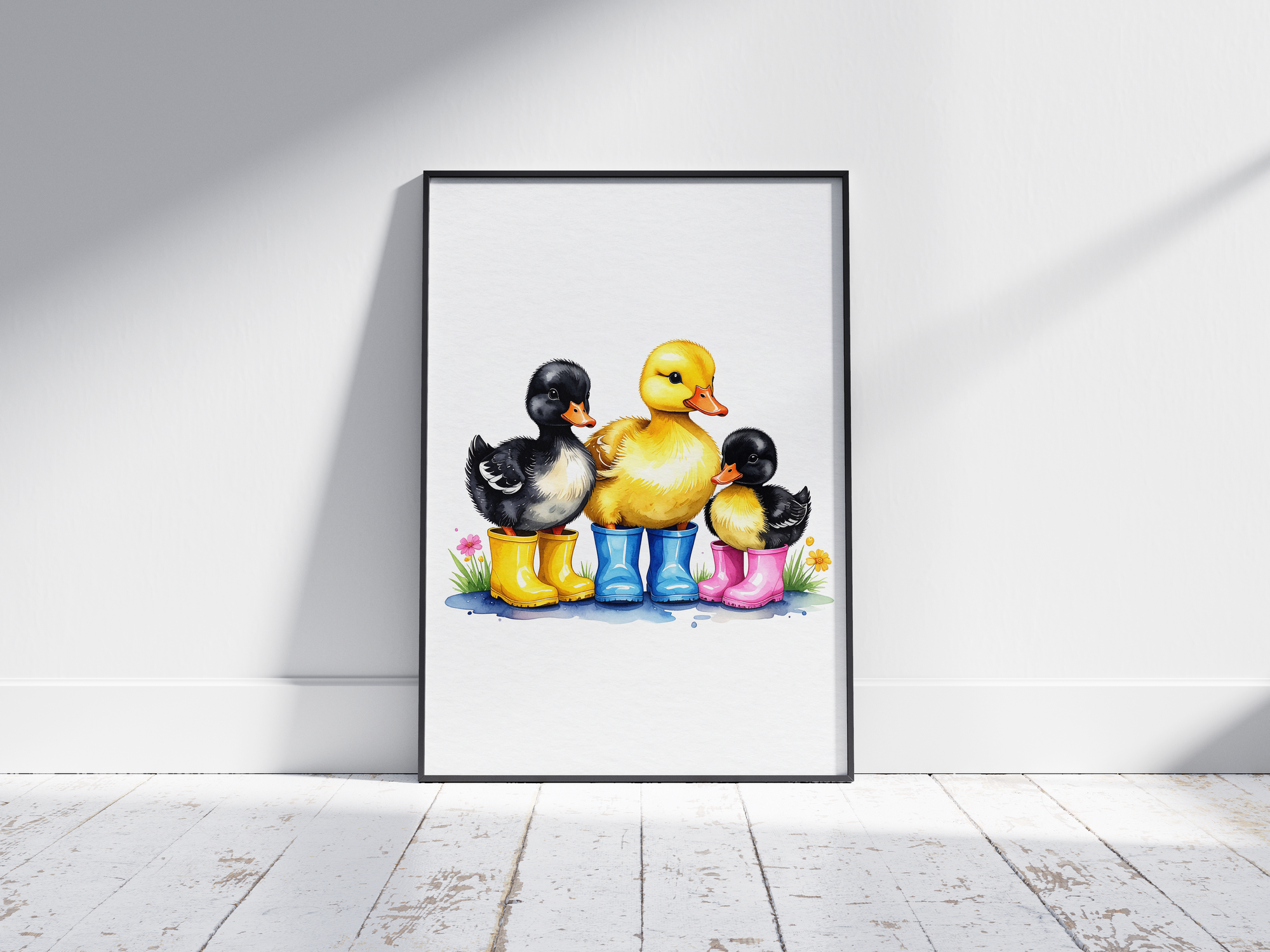 Charming watercolor art poster featuring three adorable ducklings in colorful rain boots (yellow, blue, pink) with subtle flowers, printed on semi-gloss sustainable paper. Perfect wall art for nurseries, children's rooms, or playrooms with a cute and whimsical aesthetic.