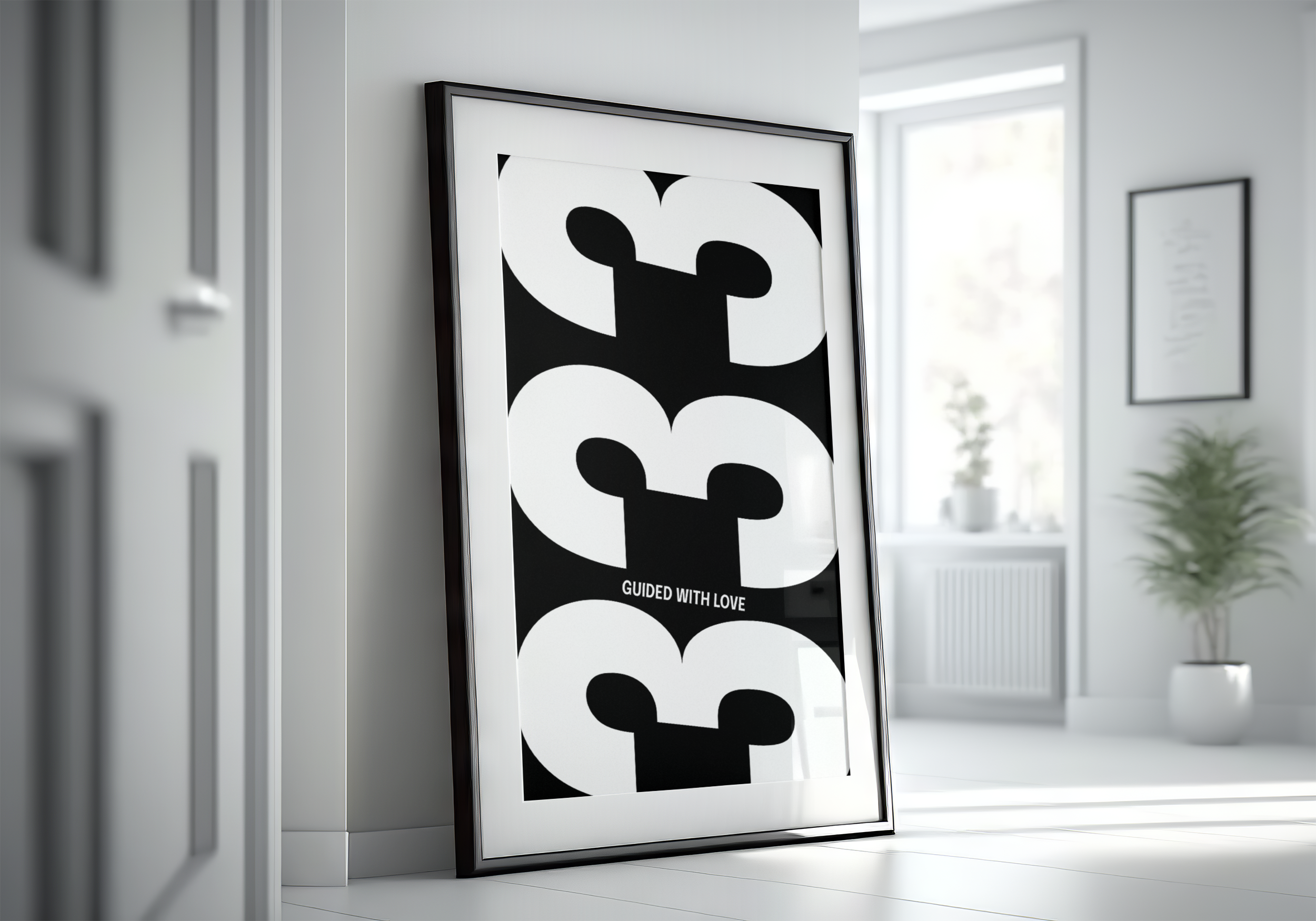 Black framed poster with the repeating number '333' in a black and white design with the text "GUIDED WITH LOVE," leaning against a white wall in a bright, minimalist room.