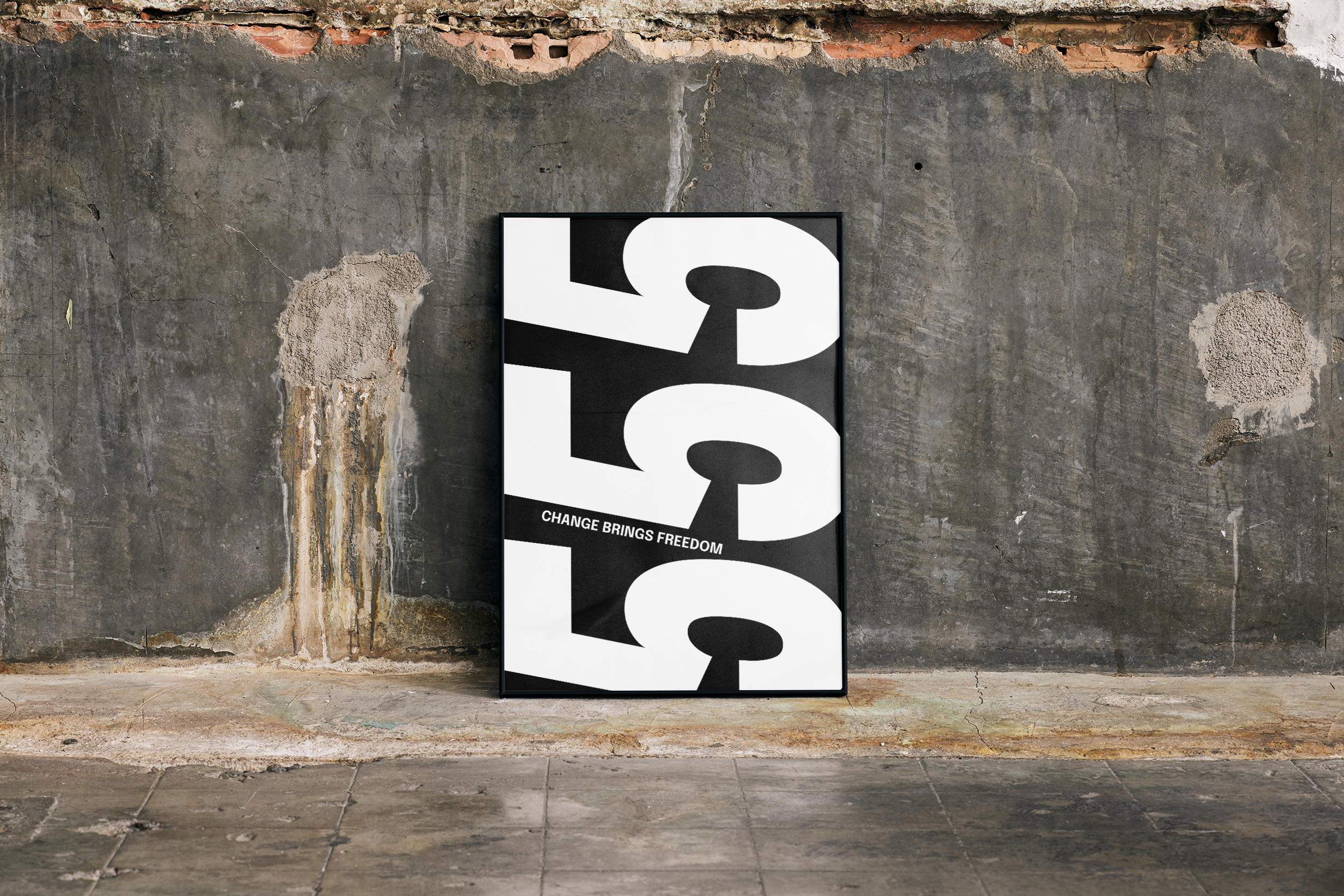 Black framed poster with the repeating number '555' in a black and white design with the text "CHANGE BRINGS FREEDOM," leaning against a rough, distressed concrete wall.