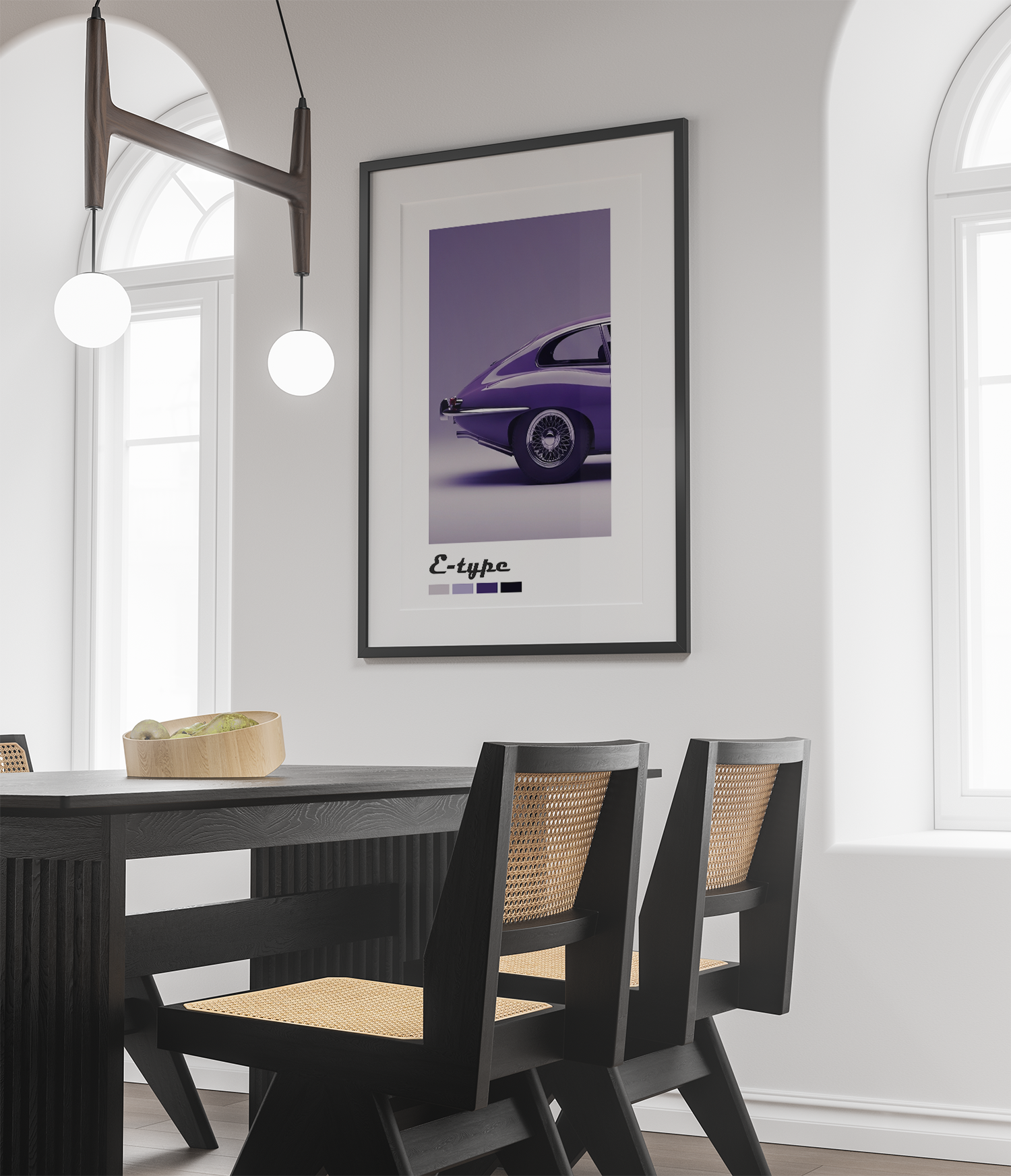 A sleek, minimalist automotive art print featuring the iconic rear quarter view of a purple Jaguar E-Type car. Perfect for a car enthusiast or adding a touch of classic sophistication to a dining room or office. The framed print is centered on a light wall above a dark wooden dining set with cane-back chairs, creating a clean, high-contrast, and elegant look.
