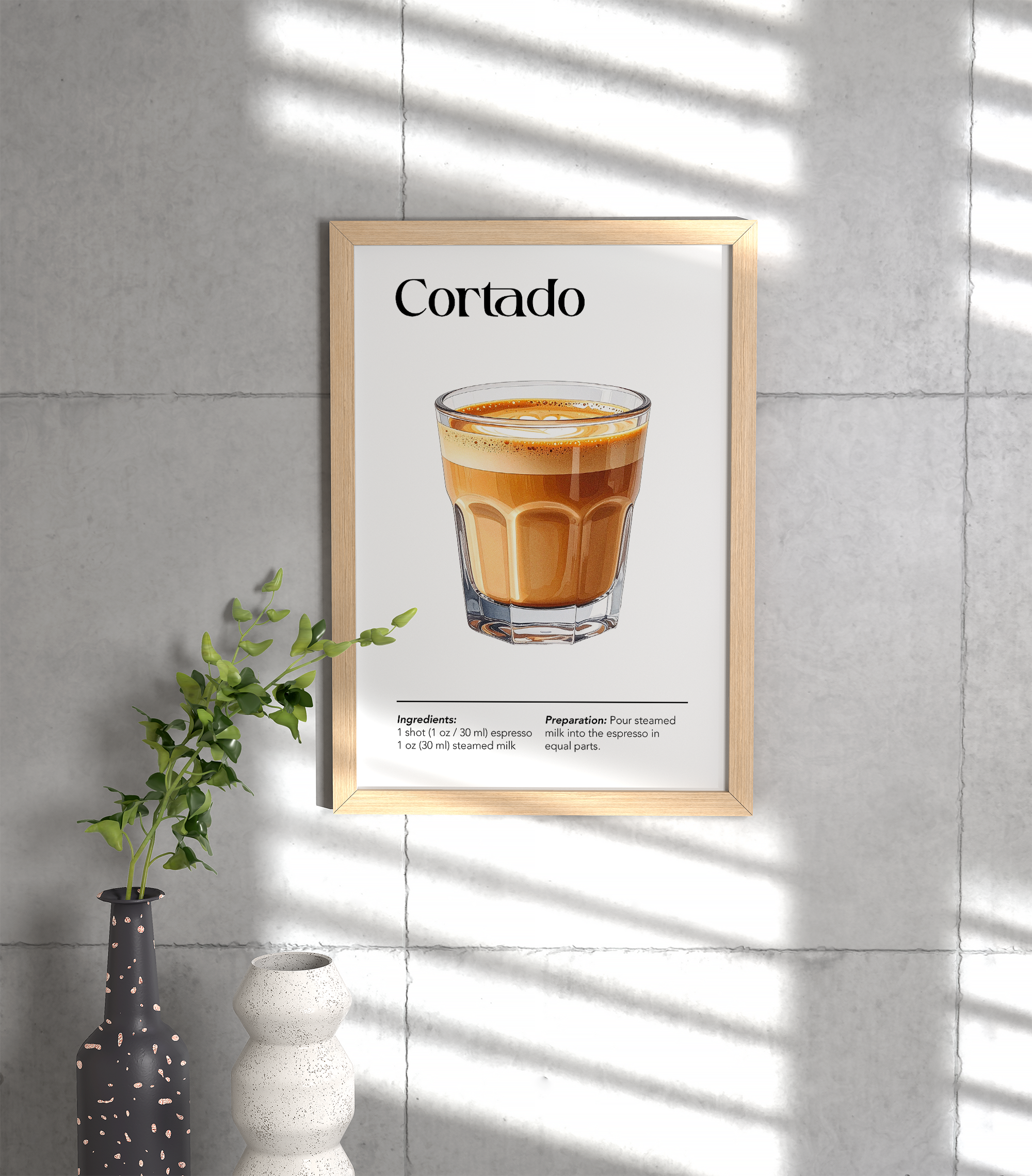 Wooden framed poster featuring an illustration of a Cortado with ingredients and preparation instructions, hanging on a light grey tiled wall, next to a vase with a green plant.