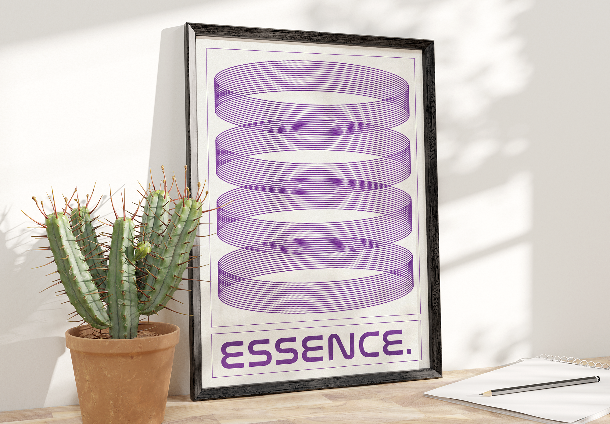 A black framed poster with the word "ESSENCE." and an abstract design of four sections of concentric purple rings on a cream background, standing on a wooden surface next to a large potted cactus in a terracotta pot.