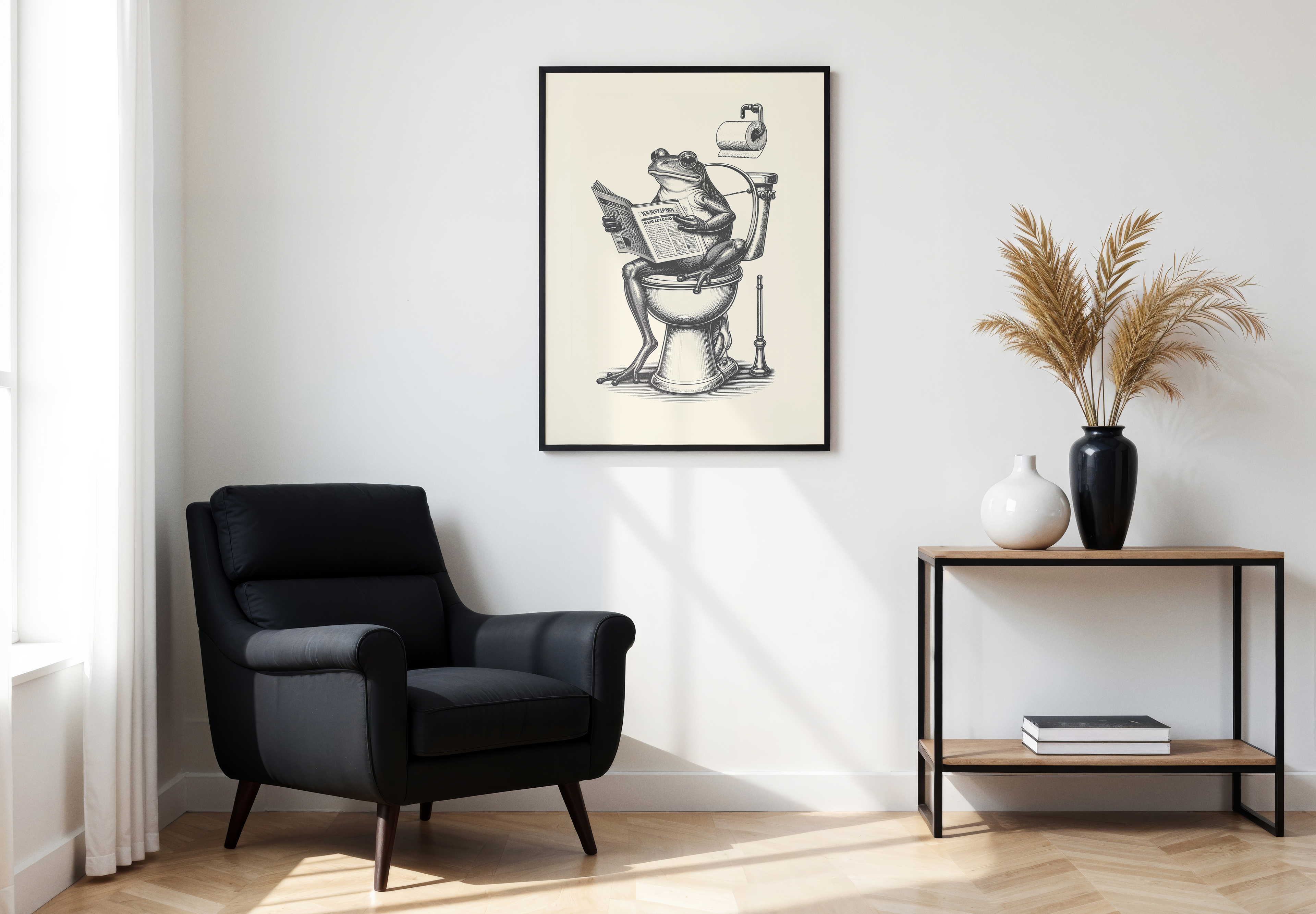 A large black-framed poster featuring an antique-style illustration of a Frog sitting on a toilet and reading a newspaper, hung above a black armchair.