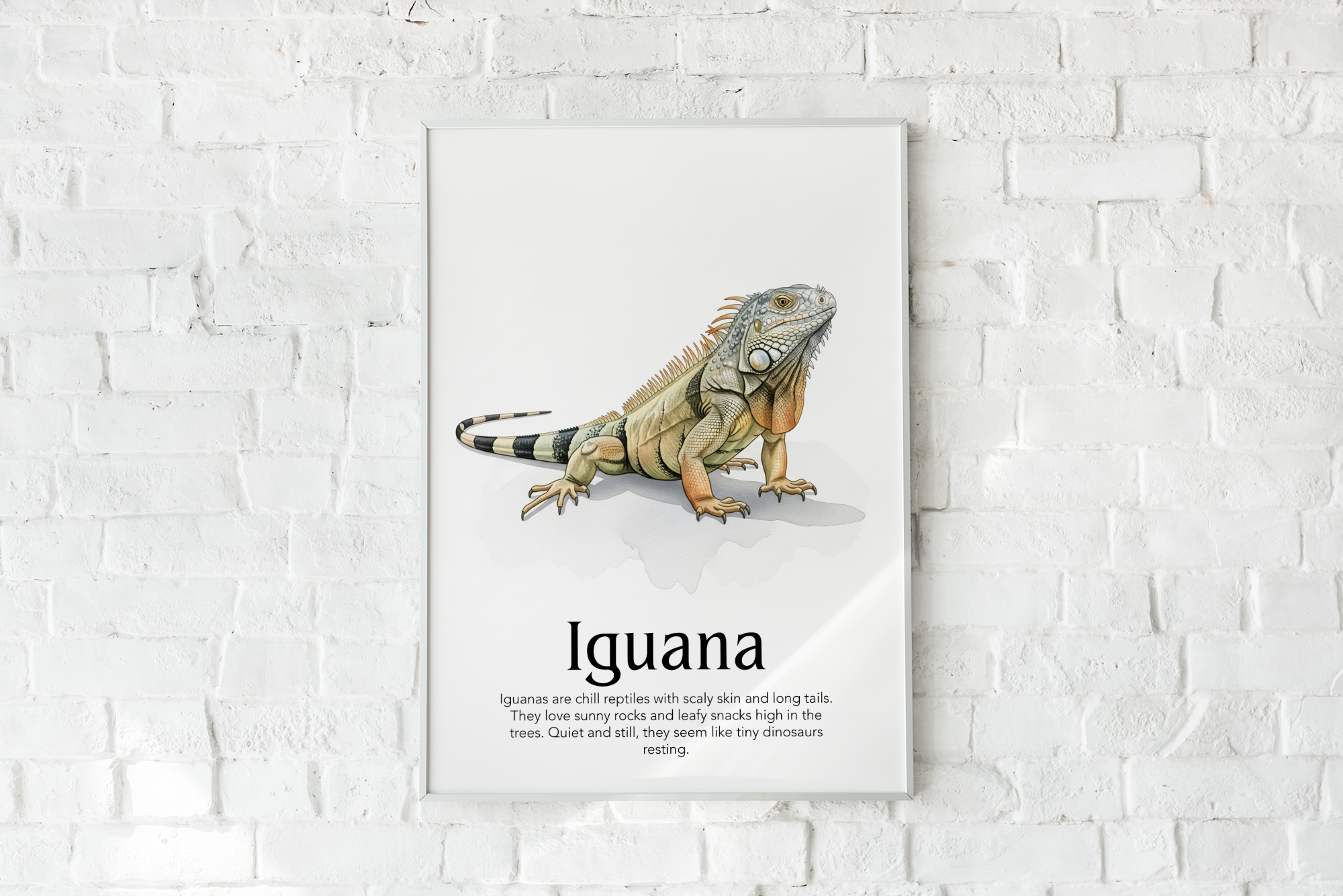 A framed poster of an Iguana illustration with text, "Iguana," hanging on a white brick wall.
