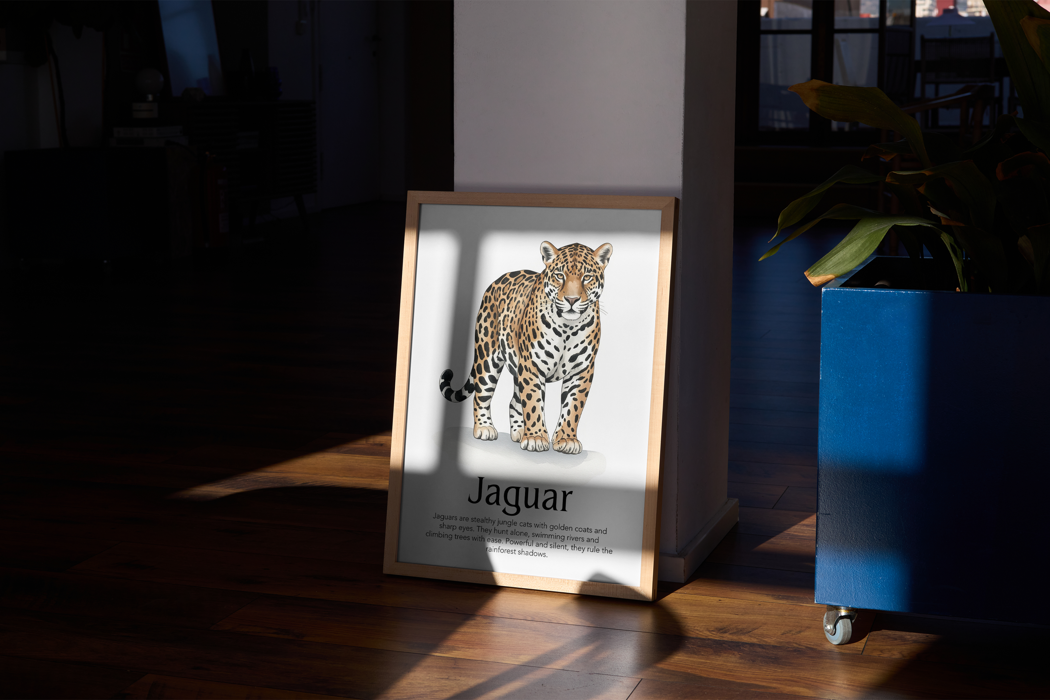 A wood-framed poster with a realistic illustration of a Jaguar and descriptive text, leaning against a wall in a hallway with dark wood floors and a blue planter.