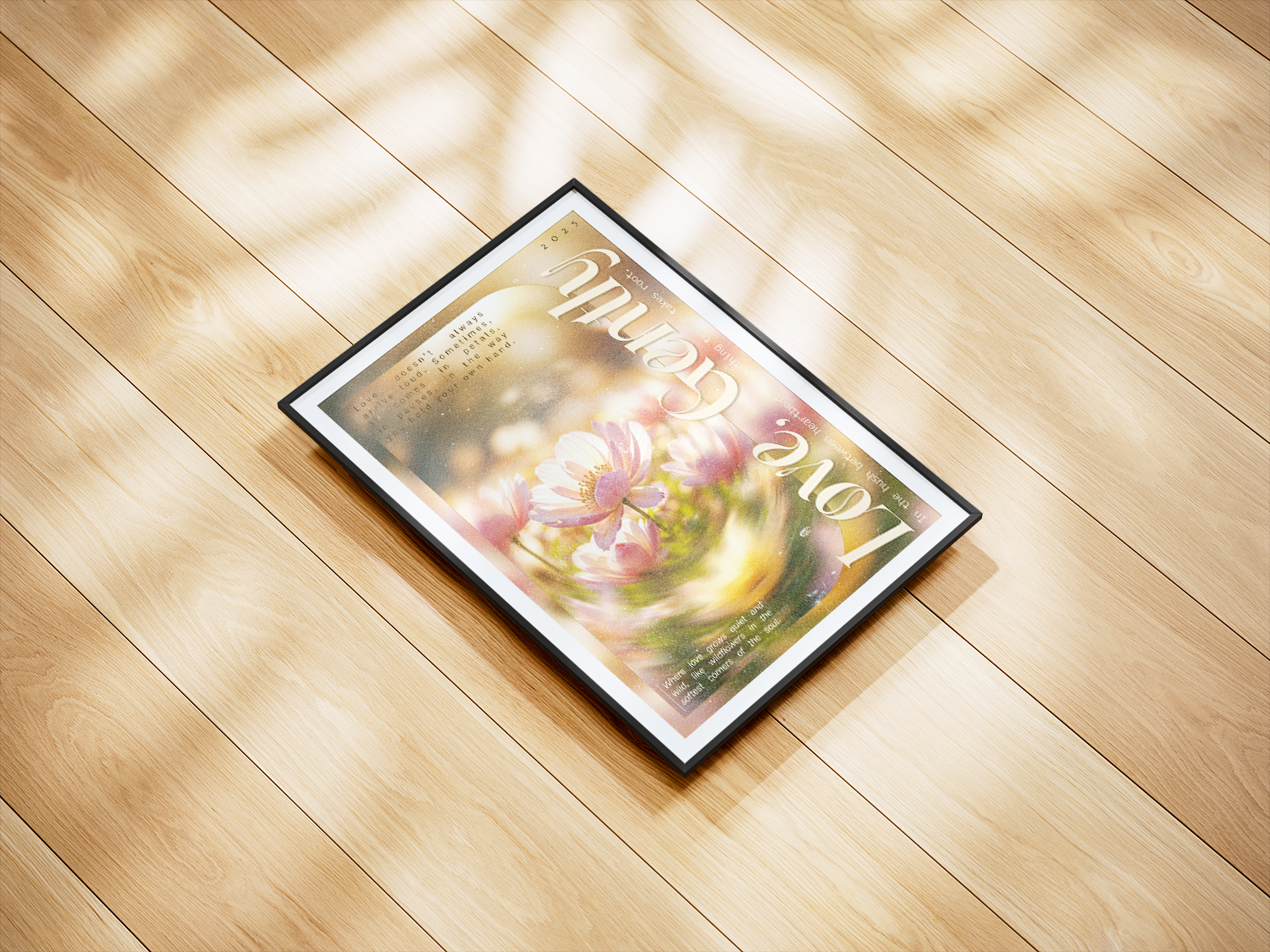 A dreamy, soft-focus abstract art print centered around a delicate pink and white flower, overlaid with the words "Love" and "Gently" in swirling, artistic typography. This poster includes inspiring text about love, perfect for adding a romantic, spiritual, or mindful touch to a bedroom or meditation space. The black-framed print is lying on a light wooden floor, capturing soft light and leaf-pattern shadows.