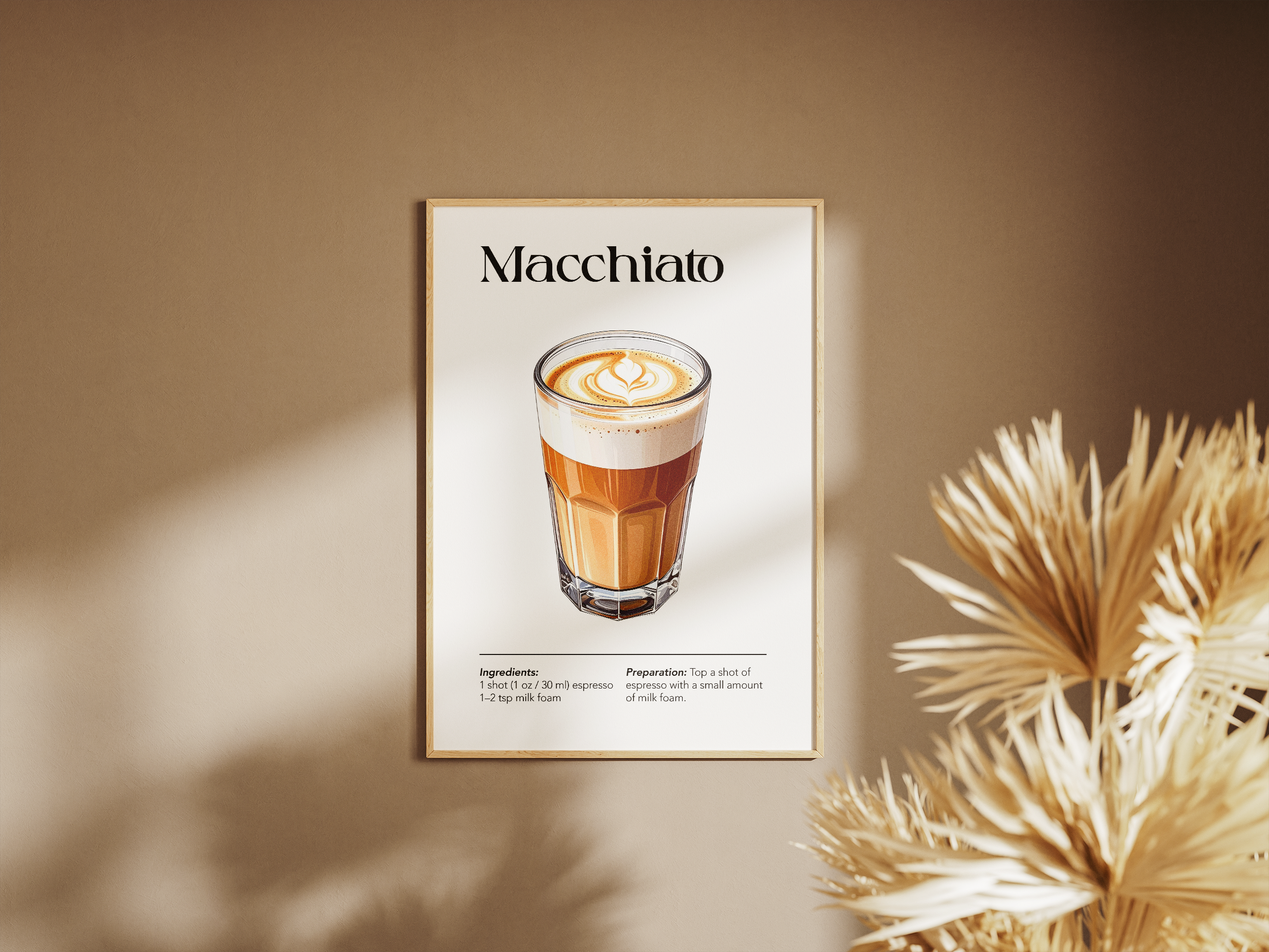 A wooden-framed poster featuring an illustration of a Macchiato coffee with its ingredients and preparation instructions, hanging on a warm beige wall next to a dried ornamental plant.