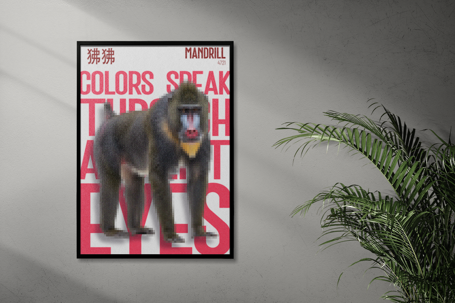 A framed poster of a Mandrill, illustrated with a pixelated effect, leaning against a textured grey wall. The large red text reads: "COLORS SPEAK THROUGH THE EYES." A leafy houseplant is partially visible on the right.