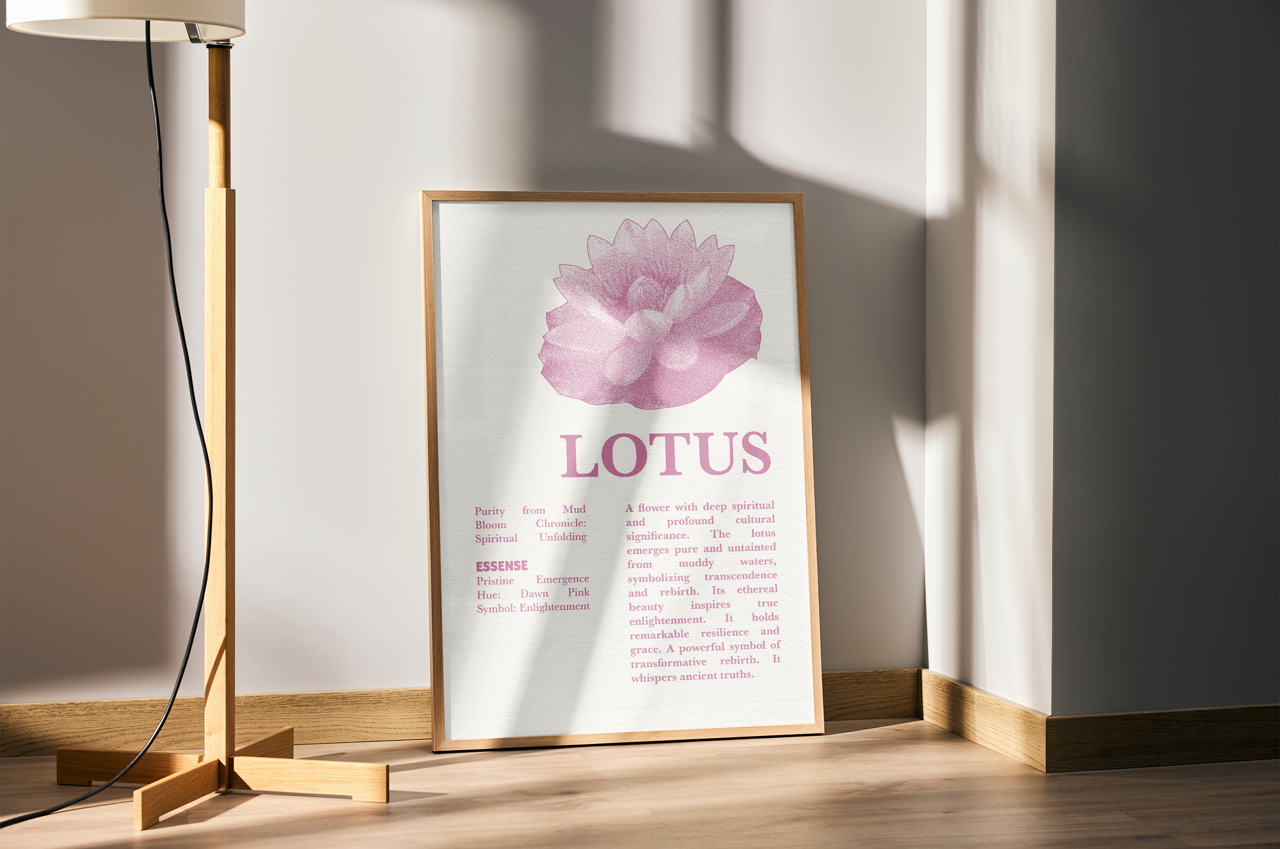 A light wood-framed poster with a pink, stipple-style illustration of a lotus flower, the title "LOTUS," and text detailing its spiritual meaning, propped against a white wall next to a wooden floor lamp.
