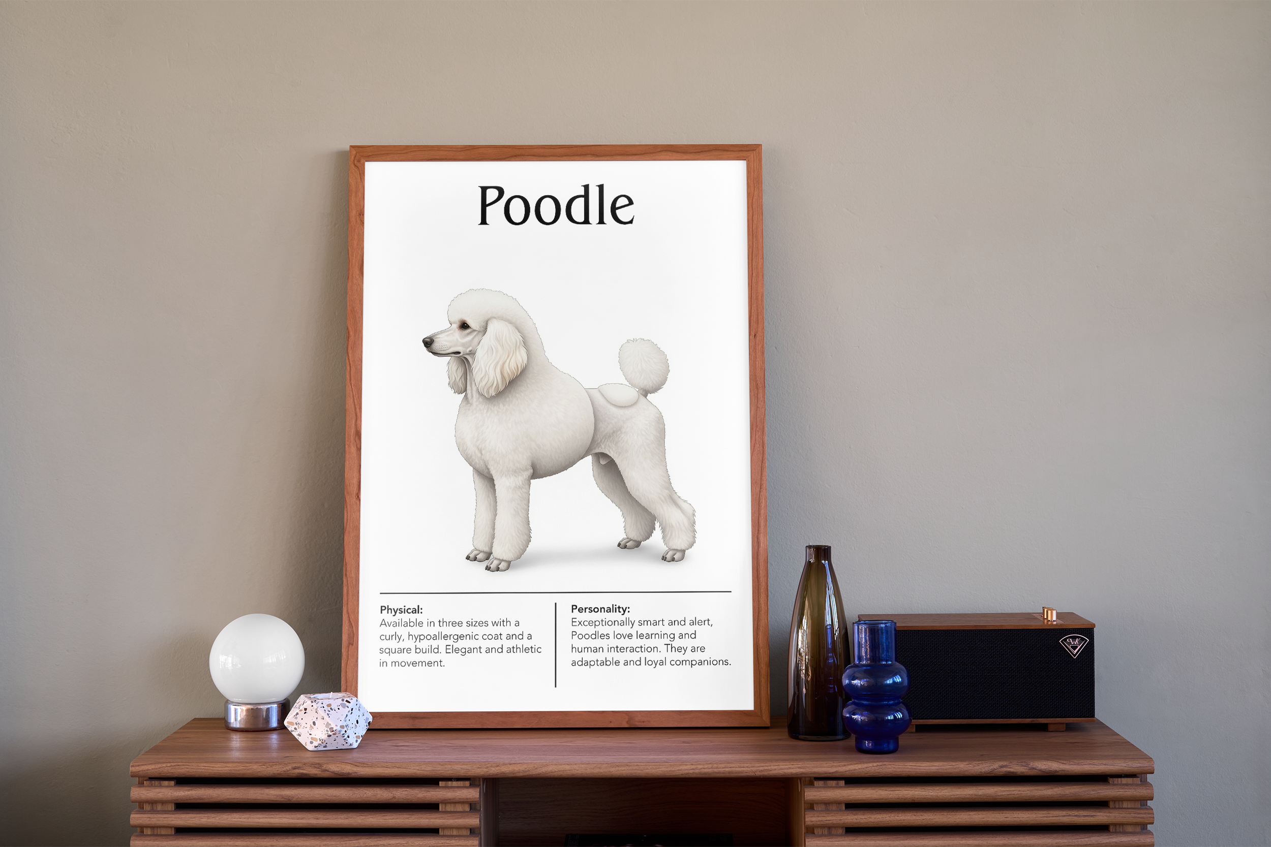 A wood-framed poster of a white Poodle, displayed on a wooden cabinet next to a dark blue vase, a speaker, and a globe lamp against a beige wall.