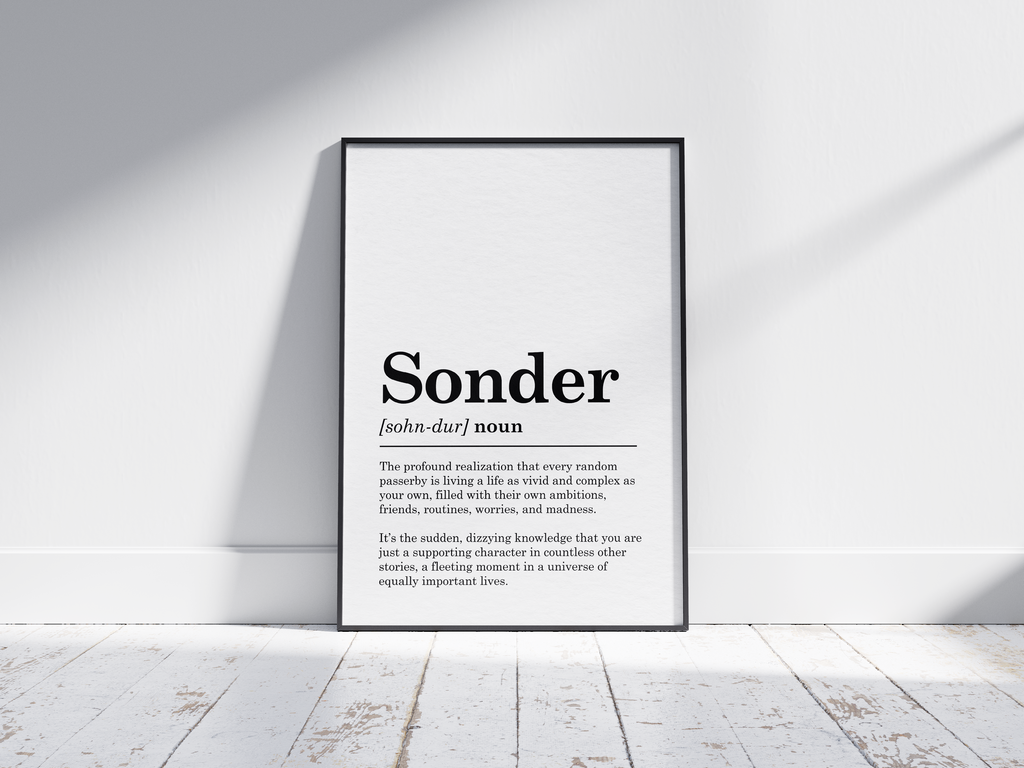 Minimalist Sonder definition poster featuring elegant black text on a crisp white background. This powerful and thought-provoking piece of wall art is perfect for adding a sense of perspective and empathy to living rooms, studies, or gallery walls with a modern or minimalist aesthetic.