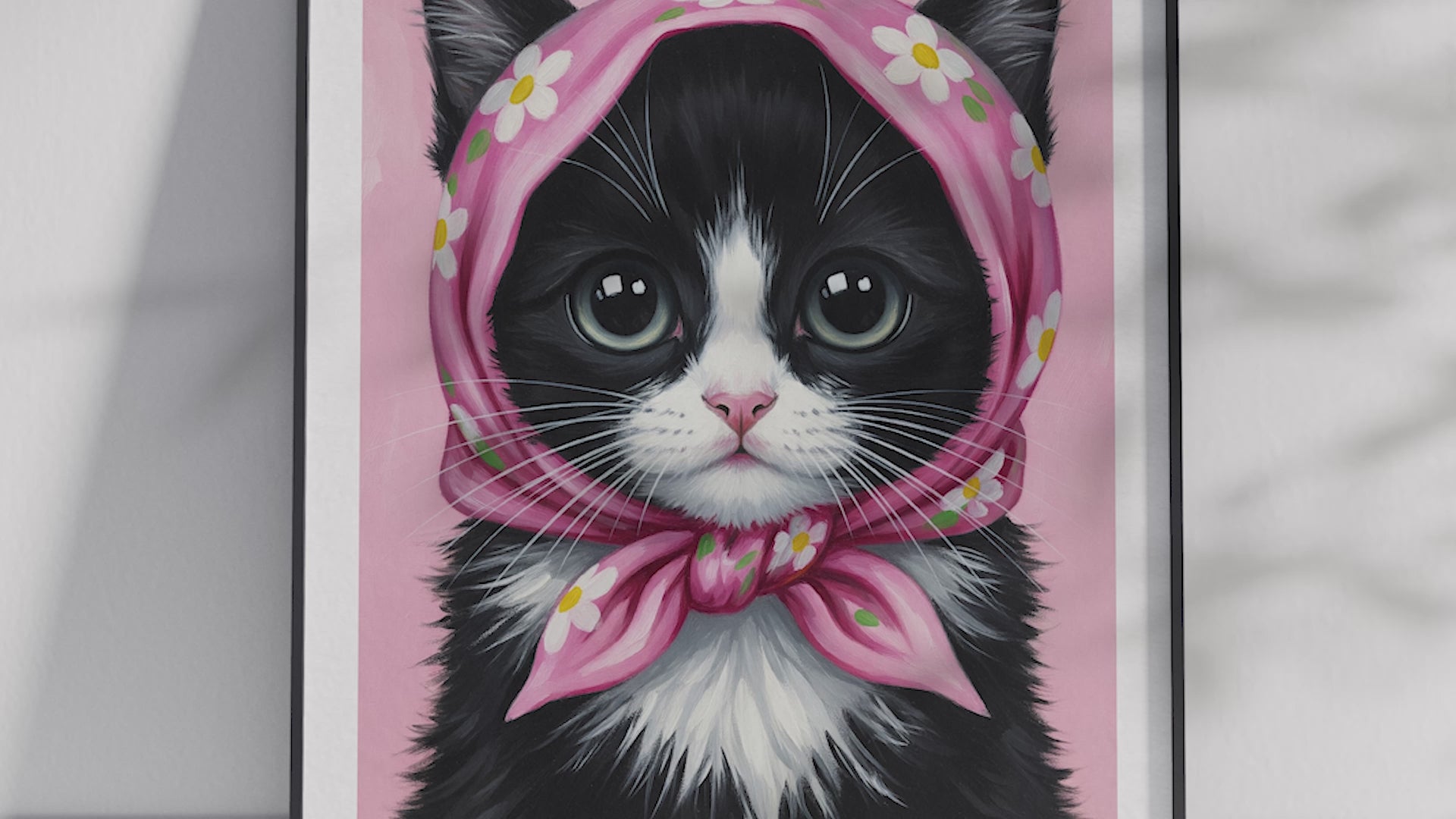 A single framed poster of a black and white kitten wearing a pink, floral babushka scarf. This whimsical art print is ideal for a nursery, kid's room, or bedroom, adding a cozy and charming touch.